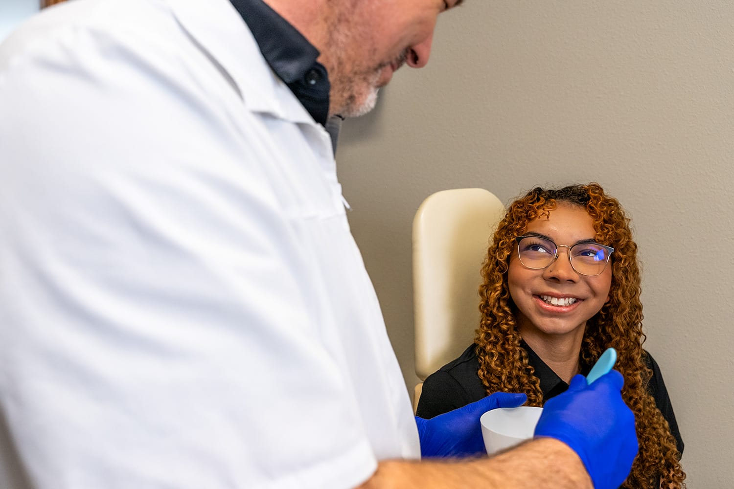 Denture-Repair-Services-2 woman smiling in denturist chair